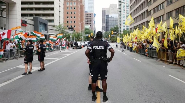 Police officers stand guard as Pro-Khalistan supporters gather for a demonstration in front of the Indian Consulate in Toronto, Ontario, Canada on July 8, 2023. Pro-India counter protestors also gathered outside the Indian Consulate for a counter protest.— courtesy Getty Images