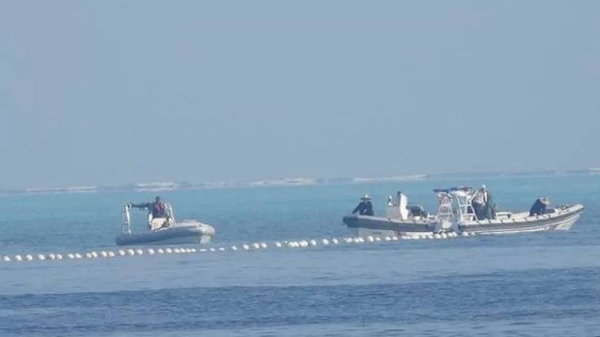 Chinese coast guard boats were seen close to the floating barrier on Wednesday