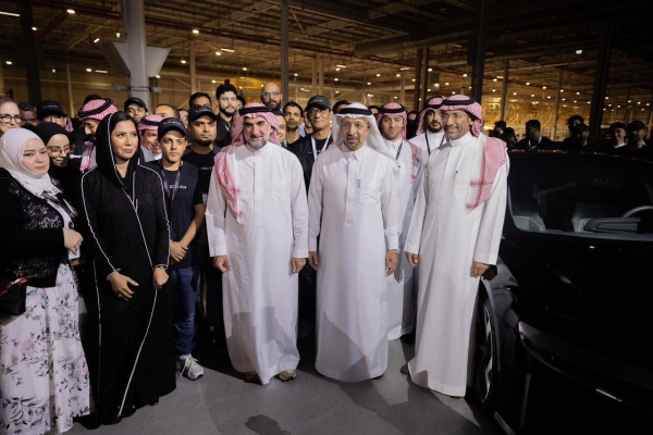 Saudi officials pose for a picture with Lucid's technical team in the new factory.