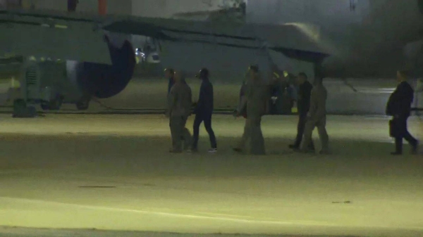 A screengrab from a video shows an individual who appears to be Travis King, third from right, deplaning after landing at Kelly Field near San Antonio on September 28, 2023