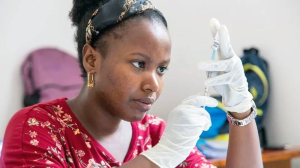 Woman preparing malaria vaccine. — courtesy University of Oxford