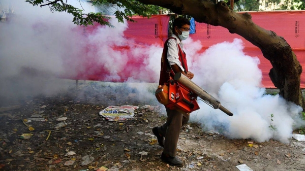 A worker sprays mosquito repellent outside a hospital in Dhaka, Bangladesh, on September 9