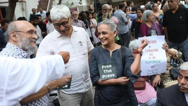 Booker Prize-winning novelist Arundhati Roy, pictured in grey, was among those who attended a protest on Wednesday