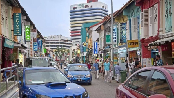 Tourists walking past colourful shops in Little India in Singapore