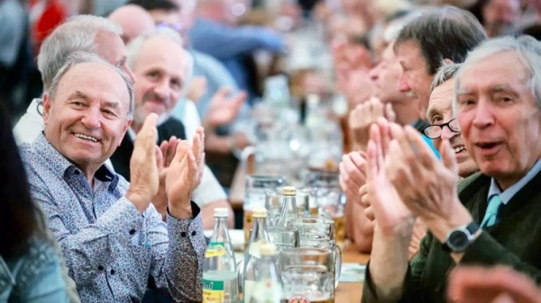 
Supporters of Freie Wähler leader and Bavarian Deputy Premier Hubert Aiwanger applaud at a campaign event in a beer tent. — courtesy Getty Images