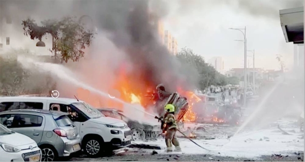 A screengrab shows an area on fire as rockets are launched from the Gaza Strip, in Ashkelon, southern Israel Saturday.