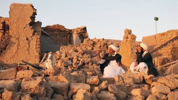 Afghan residents sit at a damaged house after earthquake in Sarbuland village of Zendeh Jan, district of Herat province, — courtesy Getty Images