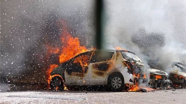 Cars are seen on fire following a rocket attack from the Gaza Strip in Ashkelon, southern Israel