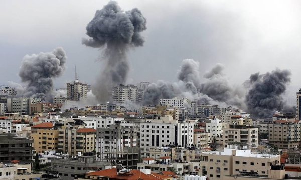 Smoke rises over buildings as the Israeli airstrikes continue in Gaza City, Gaza, on Monday. — courtesy Getty Images