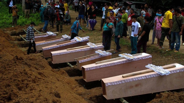 Coffins at a mass funeral to bury victims of a military strike on a camp for displaced people near the northern Myanmar town of Laiza on October 10