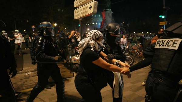 A protestor is detained by French Police during an unauthorized demonstration in support of Palestinians at Place de la Republique, in Paris, on October 12, 2023