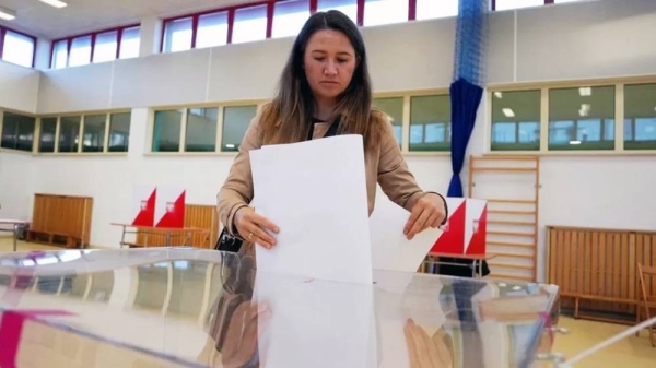 A voter in Warsaw. There were queues outside polling stations across the country. — courtesy Reuters