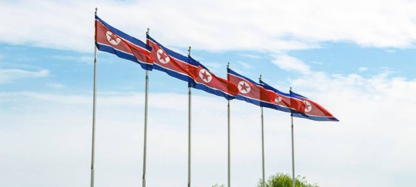 Flags of the Democratic People’s Republic of Korea fly in Pyongyang. — courtesy Unsplash/Micha Brändli