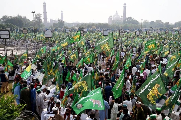 Supporters of Nawaz Sharif wait for his arrival for a welcoming rally at a park in Lahore on Saturday. — courtesy AFP/Getty Images