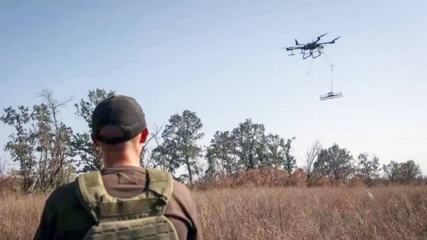 A member of the volunteer organization ‘Postup’ operates a drone with a metal detector for mine searching during demining a field, near the town of Derhachi, Kharkiv region. — courtesy Reuters