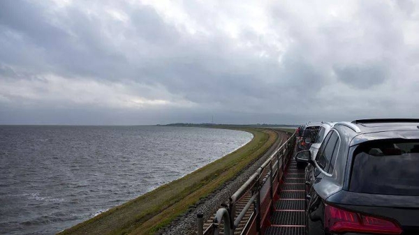 A Deutsche Bahn car train travels over the Hindenburg Dam to the North Sea island of Sylt, from Niebull, Germany, Sunday, July 23, 2023