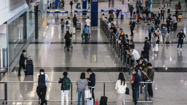 Passengers arrive at Hong Kong International Airport on February 17, 2023