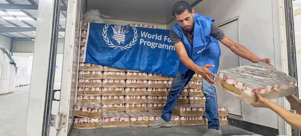 A worker unloads ready-to-eat rations from a truck close to Alexandria, Egypt, in preparation for delivery to Gaza. — courtesy WFP/Amira Moussa