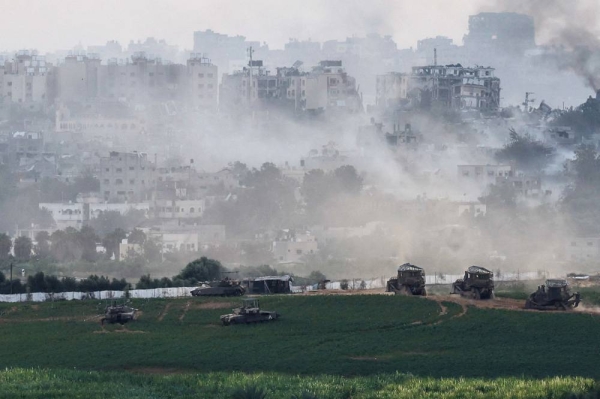 Israeli tanks and  other military vehicles manoeuvre inside the Gaza Strip, as seen from Israel, October 29, 2023. REUTERS/Evelyn Hockstein