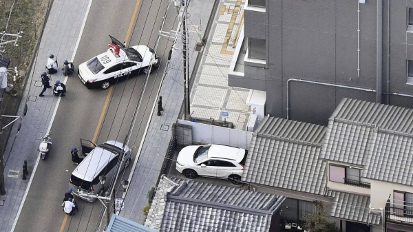 First responders take position outside the post office where a man is believed to holed up in Warabi, Saitama prefecture, north of Tokyo, on October 31, 2023