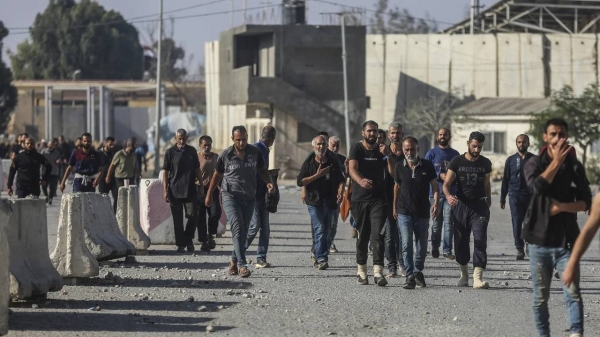 Palestinian workers arrive through the Rafah crossing into southern Gaza on Friday, after Israel said it would expel Gazan laborers.