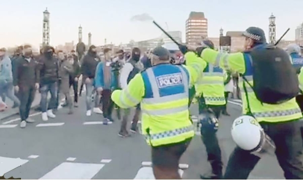 Missiles thrown as counter-protesters in police stand-off in London.