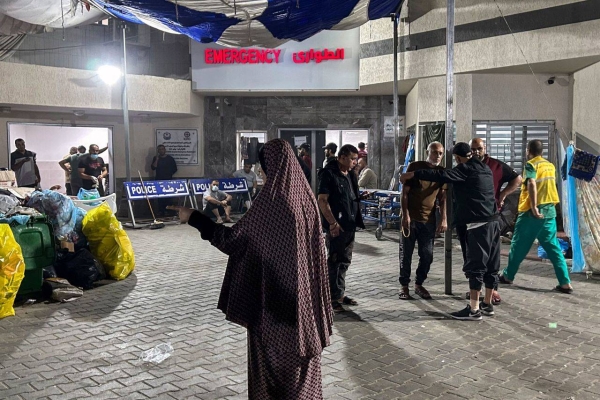 People stand outside the emergency ward of Al-Shifa hospital in Gaza City on November 10.