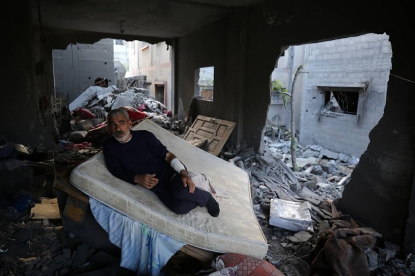 A Palestinian man stis in his home destroyed during the Israeli bombardment of Gaza, in Deir el-Balah, in the central Gaza Strip on November 15, 2023, amid ongoing battles between Israel and the militant group Hamas. 
 (Photo by Majdi Fathi/NurPhoto via Getty Images)