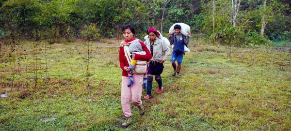 A family walks through Kayah State, in southeastern Myanmar, on their way to safety across the border to Thailand. — courtesy UNOCHA/Siegfried Modola