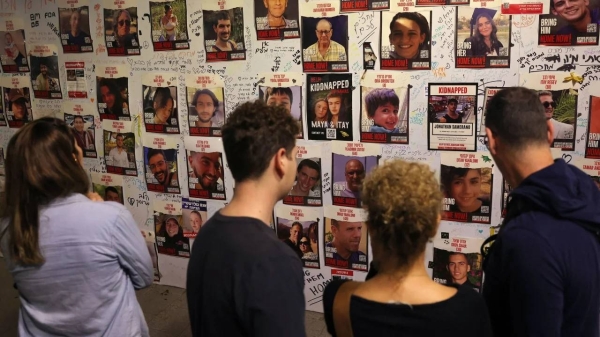 People look at pictures of Hamas hostages during a demonstration in Tel Aviv, Israel, calling for their release on November 11