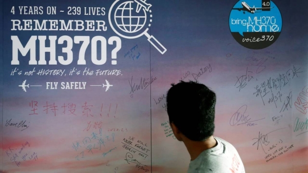 A man looks at a message board for passengers onboard the missing Malaysia Airlines Flight MH370 during its fourth annual remembrance event in Kuala Lumpur, Malaysia March 3, 2018