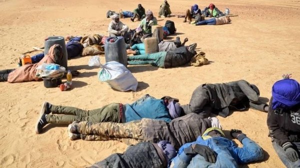 This photo from 2019 shows a group of migrant men resting before carrying on their journey across the deserts of northern Niger