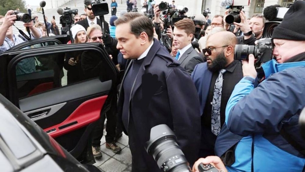 Rep. George Santos (R-NY) is surrounded by journalists as he leaves the US Capitol.