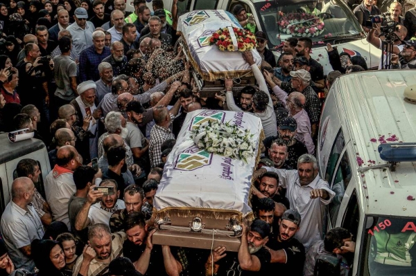 07 November 2023, Lebanon, Blida: Mourners throw rice over the coffins of  three sisters, killed along with their grandmother in an Israeli strike a day earlier, during their funeral procession in the Lebanese southern border village of Blida. Three Lebanese girls were killed along with their grandmother when an Israeli strike hit their car on Monday while theyr were traveling between Aytaroun and Aynata in southern Lebanon. Photo: Marwan Naamani/dpa (Photo by Marwan Naamani/picture alliance via Getty Images)
