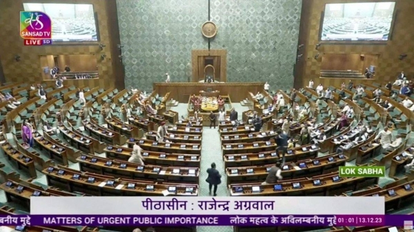 A man jumps into the lawmakers' area in the lower house of the Indian Parliament, in New Delhi, India, December 13, 2023