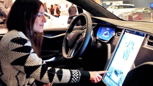 A woman in a Tesla. — courtesy Alamy