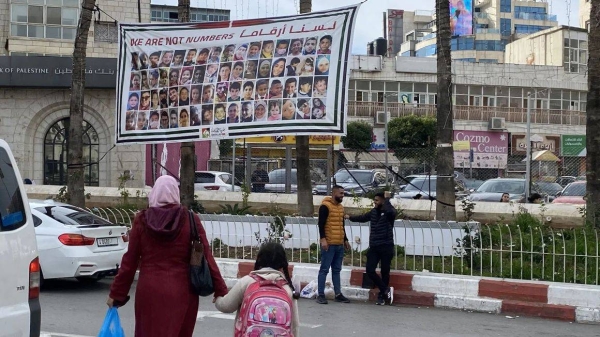 Pedestrians walk in Al-Manara square in Ramallah, in the West Bank