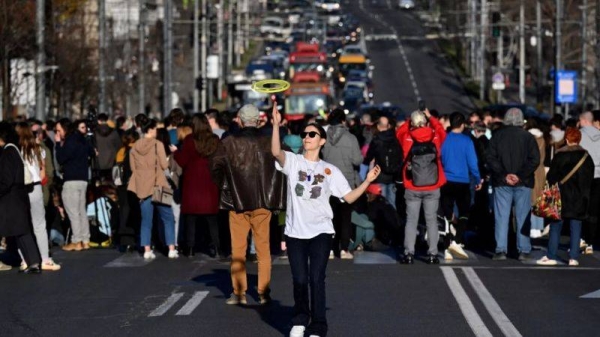 Students block one of the main streets during a protest in central Belgrade, on December 25, 2023, a week after the parliamentary and local elections in Serbia