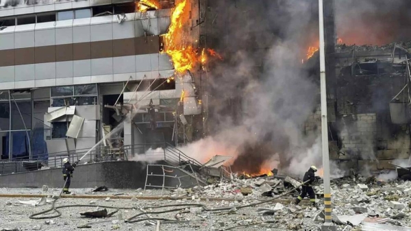 Firefighters work on a site of a building damaged after a Russian attack in Kyiv, Ukraine, Friday, Dec. 29, 2023