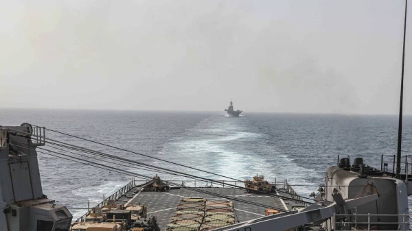 In this image provided by the US Navy, the amphibious dock landing ship USS Carter Hall and amphibious assault ship USS Bataan transit the Bab al-Mandeb strait on August 9, 2023