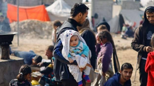 Palestinians shelter in a tent camp in Rafah