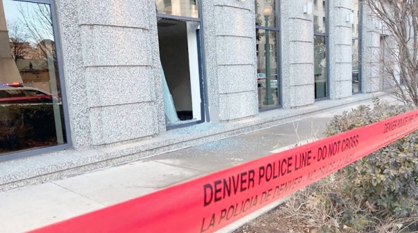 Police tape blocks the damage to large windows at the Colorado Supreme Court on Tuesday, in Denver. Authorities say a man inflicted 