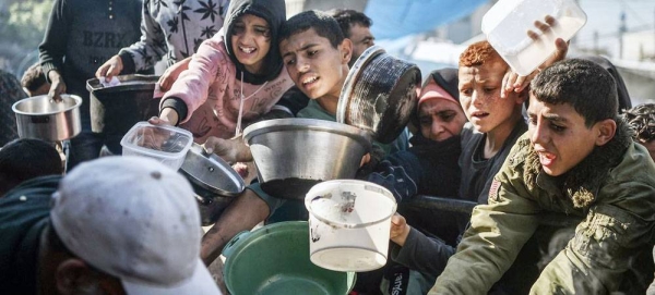 People clamor for food in the city of Rafah in the southern Gaza Strip. — courtesy UNICEF/Abed Zagout