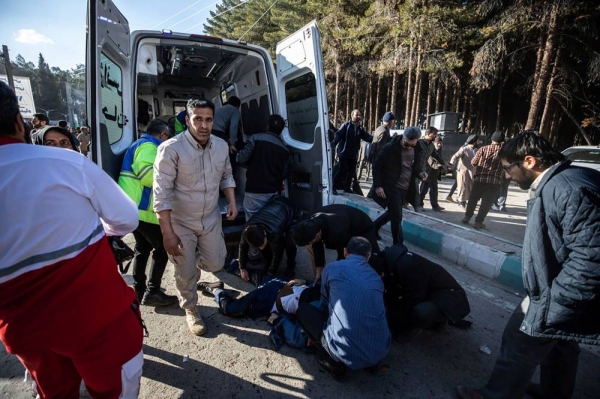 ADDS SOURCE - Injured people get aid after an explosion in Kerman, Iran, Wednesday, Jan. 3, 2024. Iran says the deadly twin bomb blasts occurred at an event honoring a prominent Iranian general slain in a U.S. airstrike in 2020.  (Mahdi Karbakhsh Ravari/Mehr News Agnecy via AP)