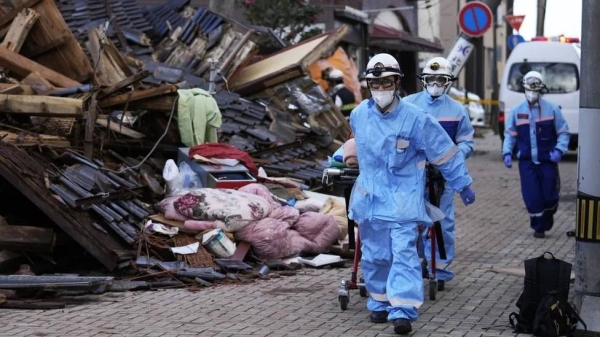 Rescue workers carry out an operation at a collapsed house following an earthquake in Wajima, Ishikawa Prefecture, Japan, 05 January 2024