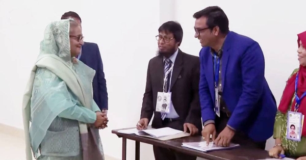 Bangladesh Prime Minister Sheikh Hasina talks to the Electoral officials after casing her vote in the Bangladesh's general election in Dhaka on Sunday.