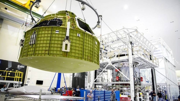 The Orion pressure vessel for NASA’s Artemis III mission is shown being lifted by crane for its move onto a work stand at NASA’s Kennedy Space Center in Florida in 2021. — courtesy Glenn Benson/NASA