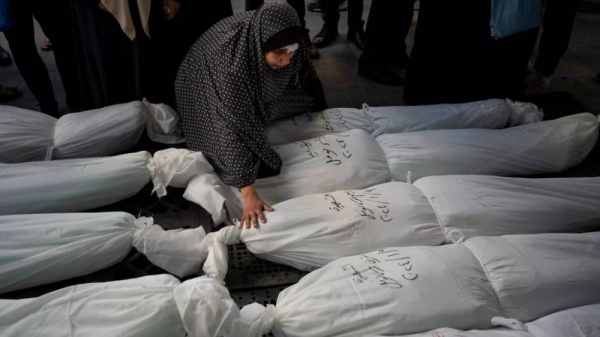 Palestinians mourn their relatives killed in the Israeli bombardment of the Gaza Strip, outside a morgue in Rafah, southern Gaza, Wednesday, Jan. 10, 2024