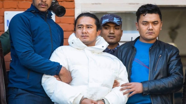 Nepal police escort Ram Bahadur Bomjam (C), a spiritual leader whose devotees believe to be a reincarnation of Buddha, at the premises of Nepal's Central Investigation Bureau in Kathmandu on January 10, 2024