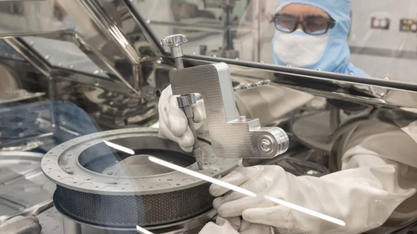 The OSIRIS-REx curation team is shown on January 10, attempting to remove one of the fasteners that prohibited the complete opening of the Touch-and-Go Sample Acquisition Mechanism, or TAGSAM, sample head